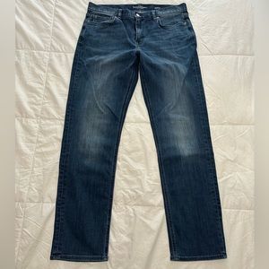 Banana Republic, Men’s “The Travler” slim jeans in dark wash.